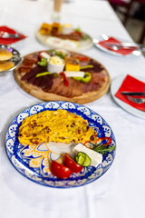 Traditional Serbian Breakfast Table with Meza, Eggs, and Sides