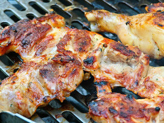 A rack of chicken is on a grill