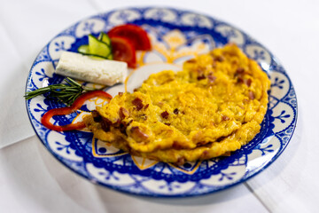  Scrambled Eggs with Bacon and Fresh Vegetables on Plate