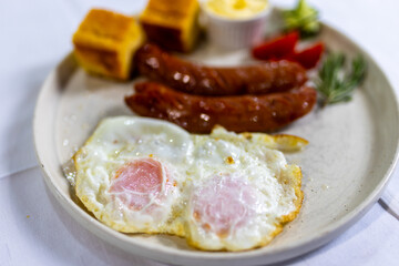 Fried Egg with Sausages and Fresh Sides on Plate