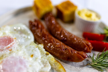 Fried Egg with Sausages and Fresh Sides on Plate