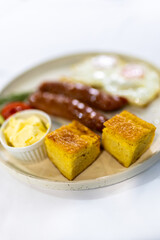 Fried Egg with Sausages and Fresh Sides on Plate