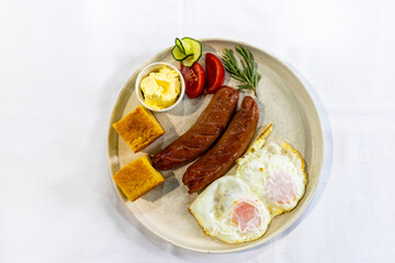 Fried Egg with Sausages and Fresh Sides on Plate