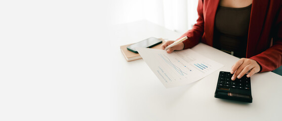 Accountant working on desk using calculator to calculate financial report in office business...