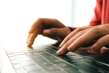 Close-up portrait typing keyboard on laptop computer. Working online on white table at office. Facebook chat. Website meeting. Blogger. Journalist writing articles. online job ideas