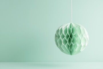 Mint green honeycomb paper lamp hanging on white background