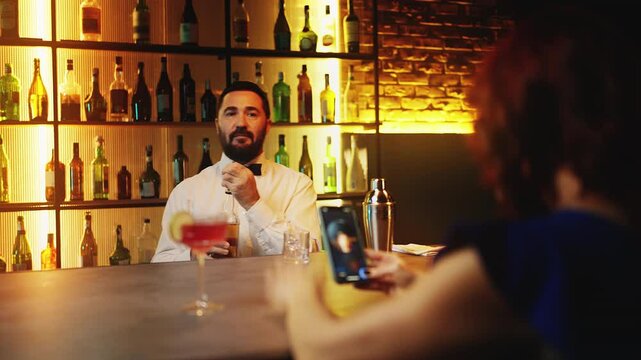 Nervous woman recording video message at bar counter, reacting to recent breakup