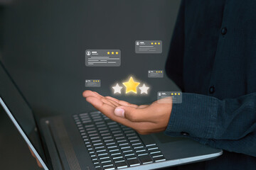 Online Review Rating Stars and Customer Feedback on Hand with Laptop
