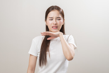 Hot weather and health care concept asian young woman suffering from heat, feeling discomfort with sunstroke at summer, hand holding on face, female gesture fatigue wearing t-shirt in high temperature
