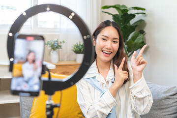 Influencer live internet, happy vlog asian young woman blogger using smart phone talking on video...