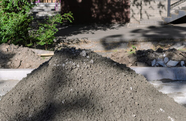 a pile of grey cement mortar on the street