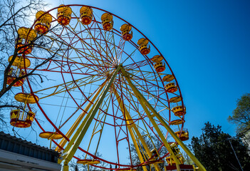 Ferris wheel on a blue sky background.