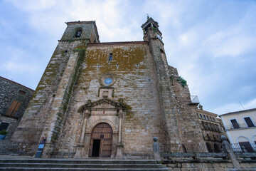A historic stone church with gothic architecture stands in Trujillo Square, Spain. The weathered...