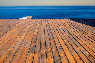 A pier near the sea made of wooden planks.