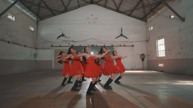 Dynamic Dance Performance in Red Dresses