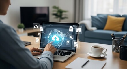 Person working on a laptop with a cloud computing interface, in a home office setting, with coffee and notebook.