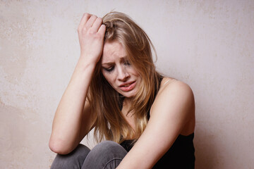 forlorn young woman with smudged makeup crying in despair feeling sad and lonely