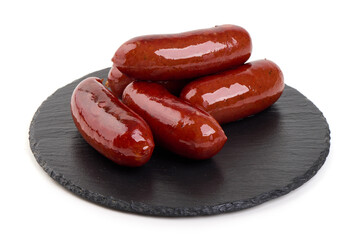 Smoked Sausages on Black Slate plate, isolated on white background