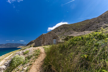 View of the beach from the top of the mountain, rocky trail leading to the picturesque beach