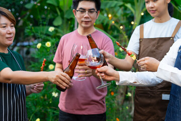People enjoying garden party with drinks and skewers