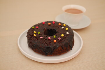 Chocolate Donut with Colorful Sprinkles and Hot Cocoa