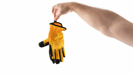 Hand holding a yellow work glove for protection