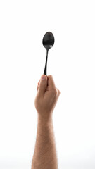 Black spoon in hand on white background