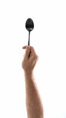 Black spoon held against white background