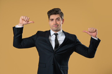 Smug businessman confidently pointing at himself with proud facial expression