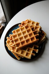 belgian waffles on blue plate and white table