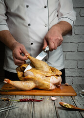 A chef skillfully cuts into a perfectly roasted chicken on a wooden cutting board. The rustic...
