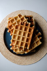 belgian waffles on a plate, round napkin and white table
