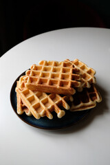 belgian waffles on blue plate and white table