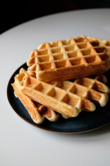 belgian waffles on blue plate and white table