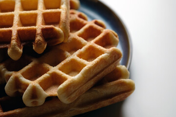 belgian waffles on blue plate and white table