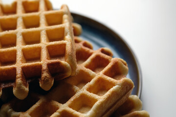 belgian waffles on blue plate and white table