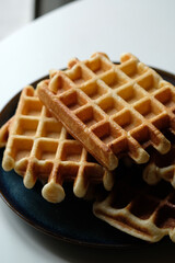 belgian waffles on blue plate and white table