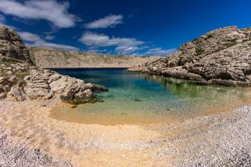 The picturesque bay and pebbly empty beach of Gnjilova on the island of KRK,