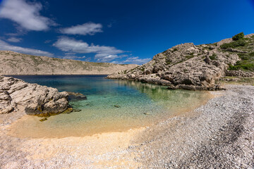 The picturesque bay and pebbly empty beach of Gnjilova on the island of KRK,