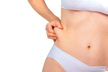 Woman pinching excess skin on her stomach. Concept of removing excess skin after weight loss,...