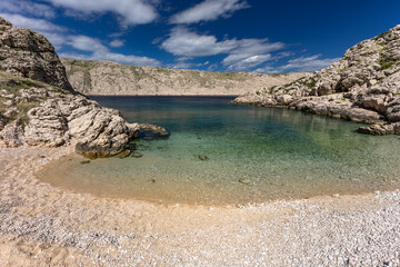The picturesque bay and pebbly empty beach of Gnjilova on the island of KRK,