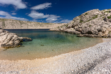 The picturesque bay and pebbly empty beach of Gnjilova on the island of KRK,