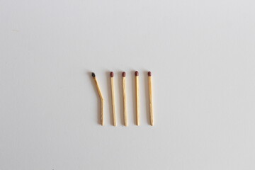 Burnt and Bent Matchstick Among New Ones: Symbol of Weakness or Collapse