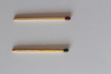 New Matchstick Next to Burnt One: Symbol of Experience vs Freshness