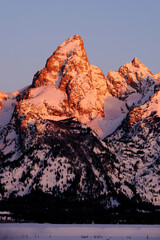 Sunrise on Teton Mountain Range in Wyoming Alpen Glow Orange and Pink on Rugged Mountains