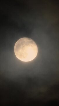 Full moon close-up with flying clouds. Supermoon in the night sky