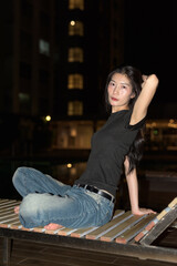 Portrait of beautiful Asian woman at night at pool during holiday