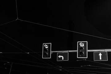 Night view of traffic lights and signs with electric wires