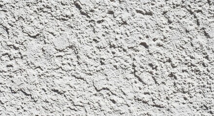 Textured White Stucco Wall: Close-Up of Rough Exterior Surface in Bright Sunlight