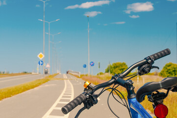 Bicycle close up at bike path in country near roadway in summer